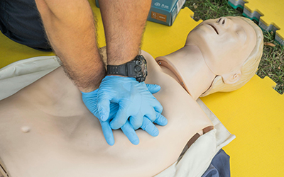 Person performing CPR on Dummy