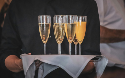 Person carrying alcohol on a tray